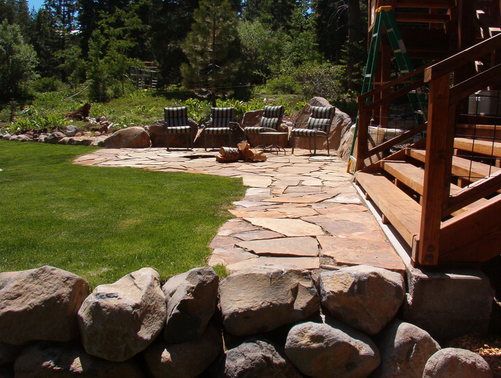 This is an example of a mid-sized traditional backyard stone outdoor sport court in Other.