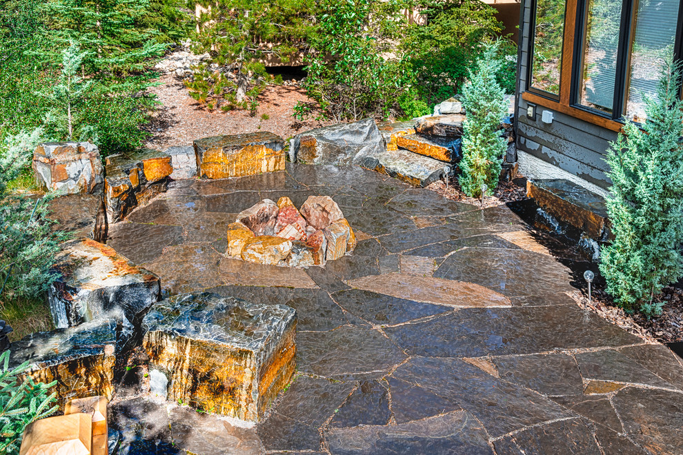 Flagstone Patio with Rock Fire Pit & Stone Seating Contemporary