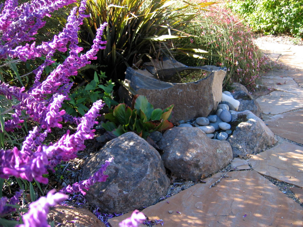 Design ideas for a medium sized rustic front full sun garden for summer in San Francisco with a water feature and natural stone paving.