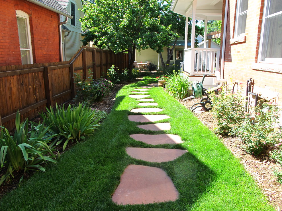 Design ideas for a small traditional shade backyard stone garden path in Denver for summer.