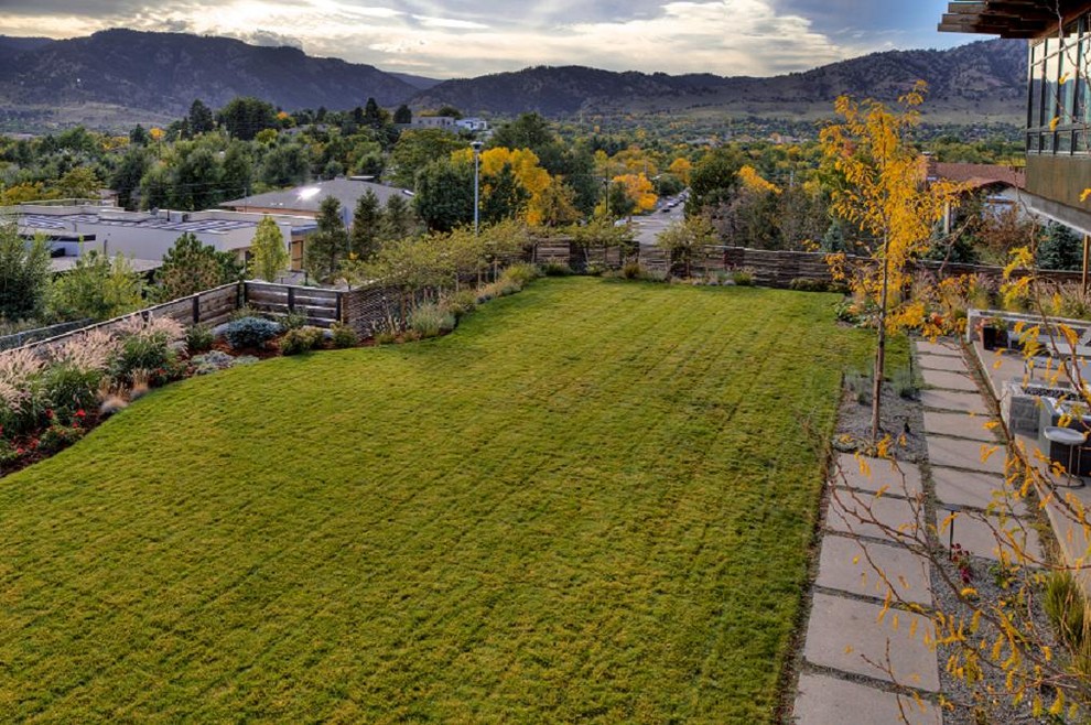 Design ideas for a large contemporary partial sun backyard gravel landscaping in Denver.