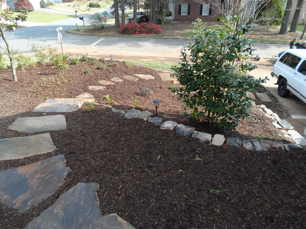 Photo of a large traditional side xeriscape full sun garden in Atlanta with a retaining wall.