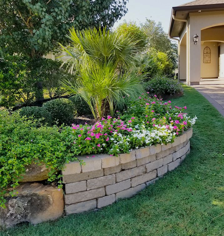 Photo of a large contemporary partial sun backyard brick landscaping in Houston.