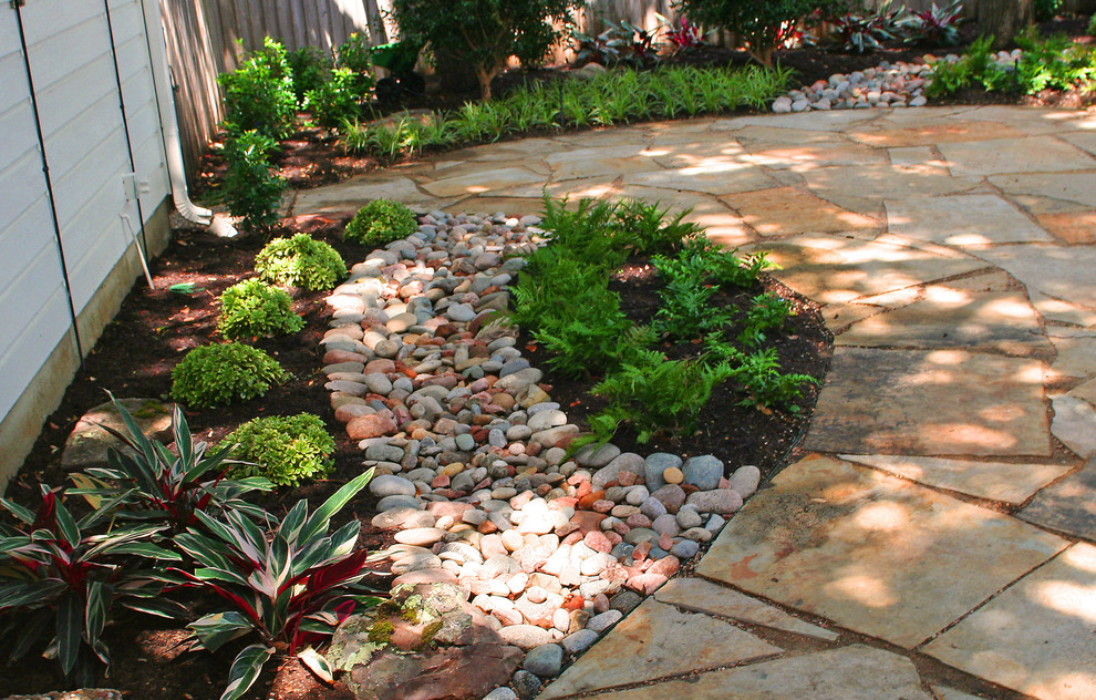 Design ideas for a traditional partial sun side yard stone garden path in Dallas for spring.