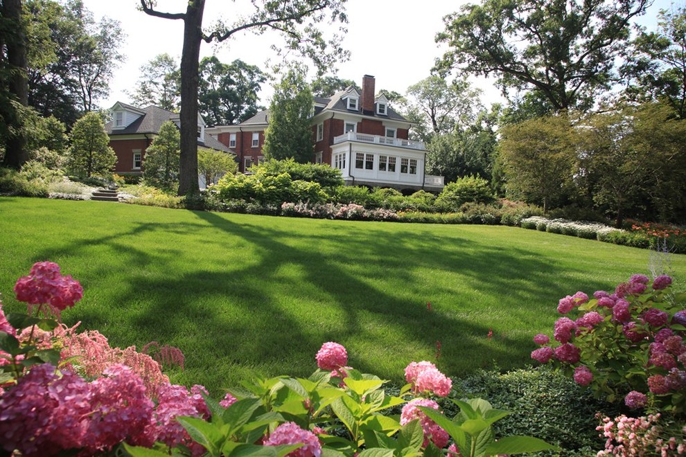 This is an example of a large traditional backyard landscaping in New York.