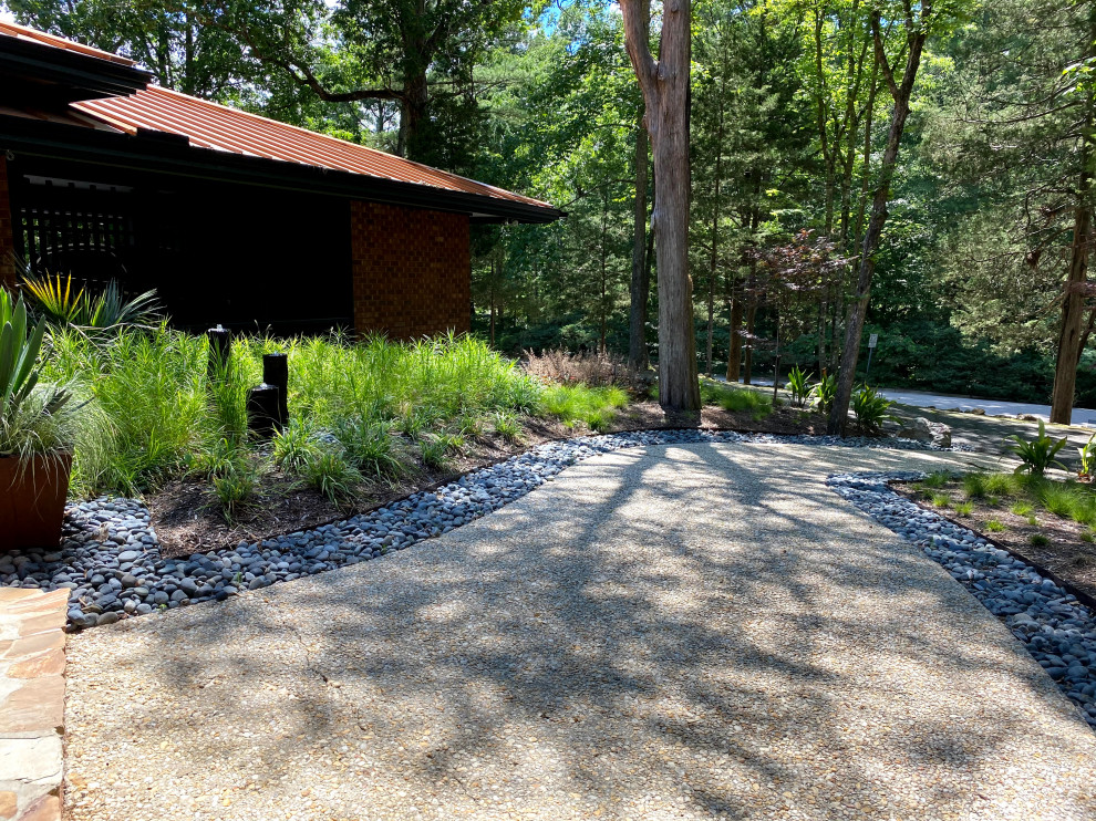 Design ideas for a large midcentury front xeriscape partial sun garden in Raleigh with a waterfall and decorative stones.