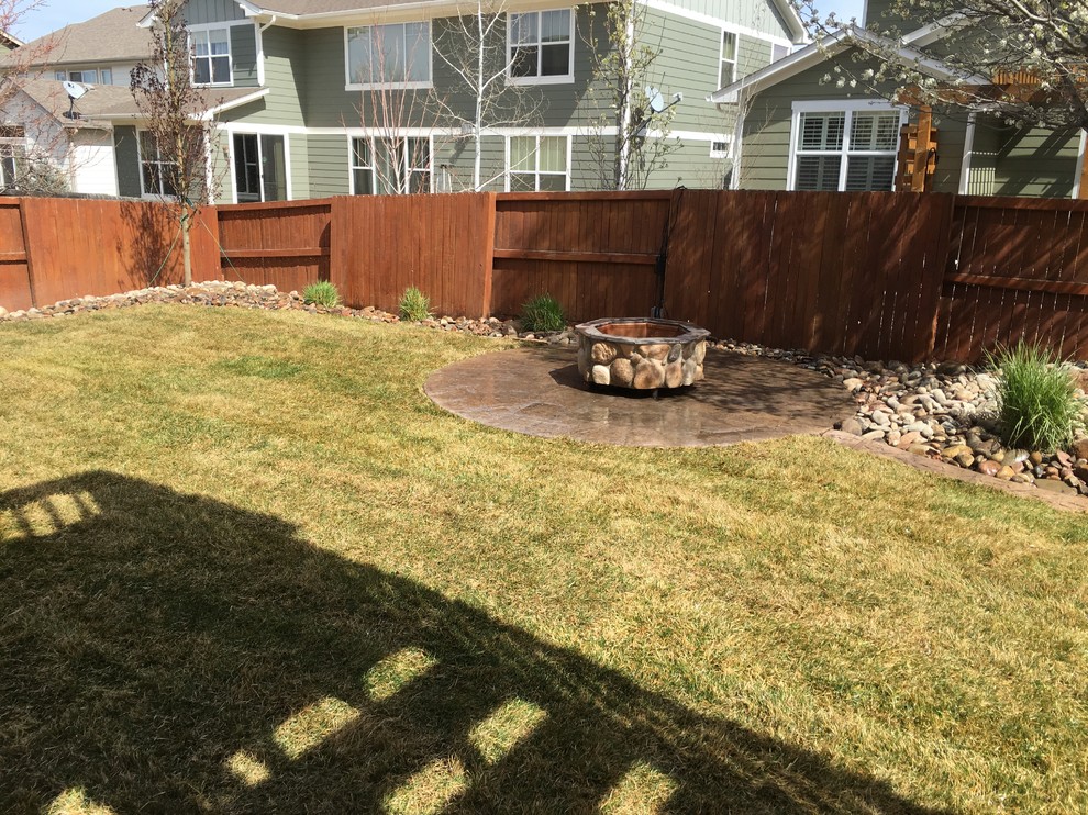 This is an example of a small traditional full sun backyard landscaping in Denver.