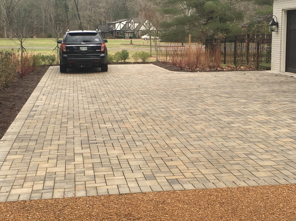 This is an example of a mid-sized traditional full sun front yard concrete paver driveway in Nashville.