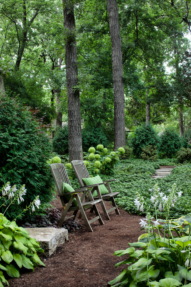Inspiration for a large traditional shade backyard mulch landscaping in Chicago for summer.