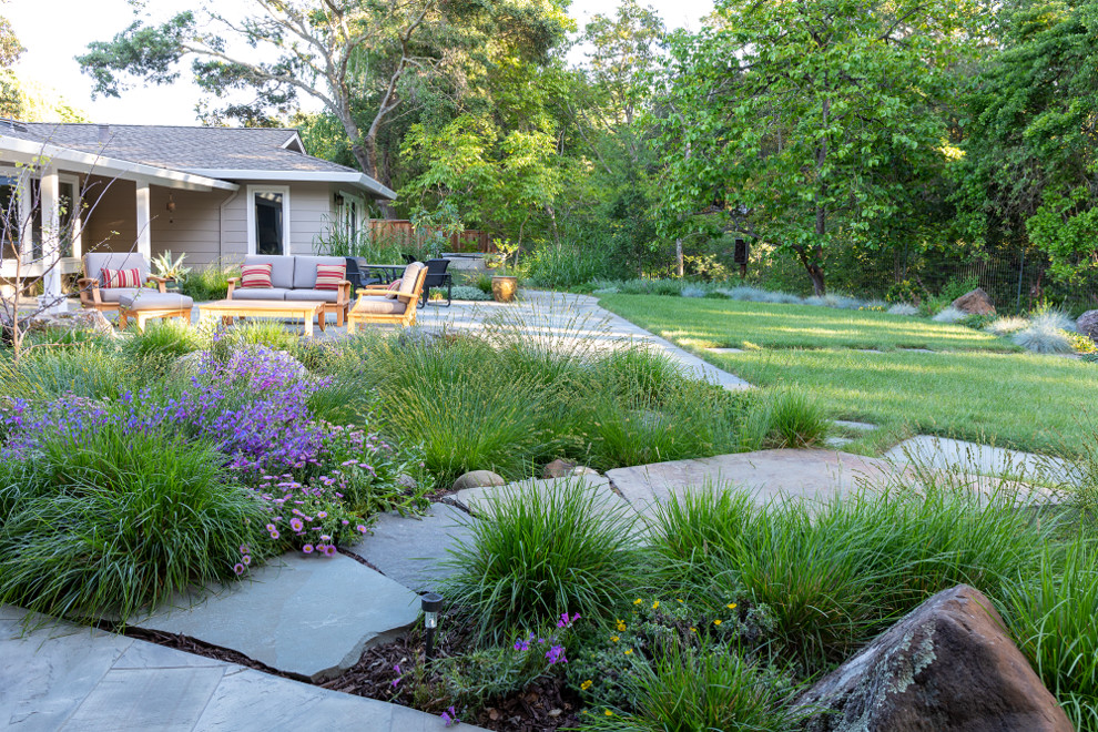 Photo of a medium sized contemporary back xeriscape partial sun garden in San Francisco with natural stone paving.
