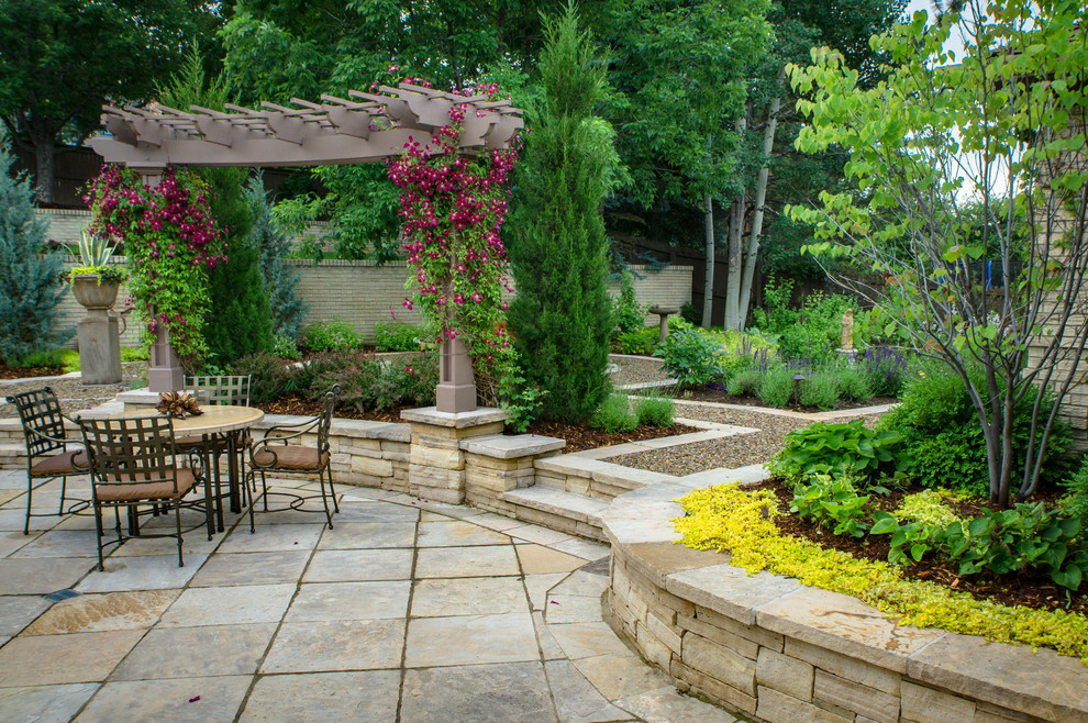 Inspiration for a traditional back formal garden in Denver with a garden path and natural stone paving.