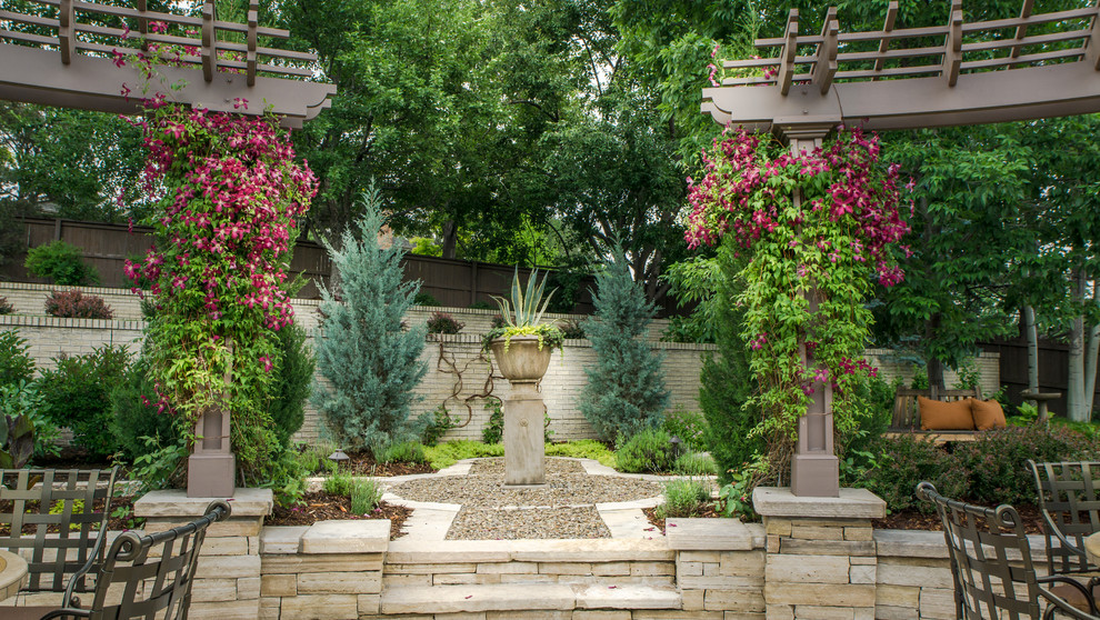 Classic back formal garden in Denver with a garden path and gravel.