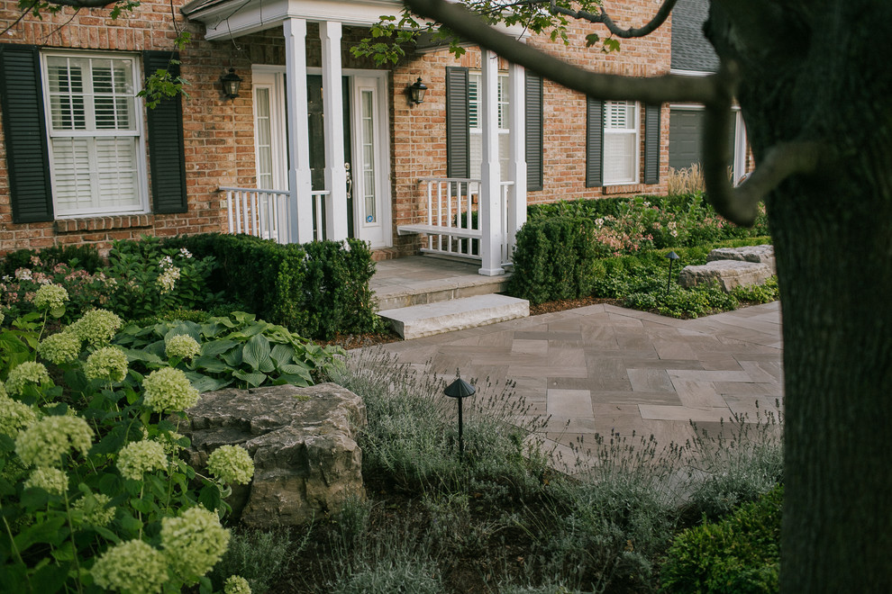 Inspiration for a medium sized traditional front formal full sun garden in Toronto with a garden path and natural stone paving.