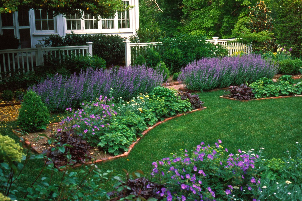Inspiration för en mellanstor vintage trädgård i delvis sol framför huset på våren, med marksten i tegel