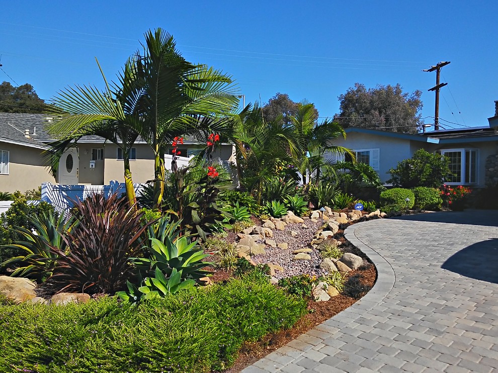 Photo of a mid-sized tropical full sun front yard concrete paver landscaping in Los Angeles for spring.