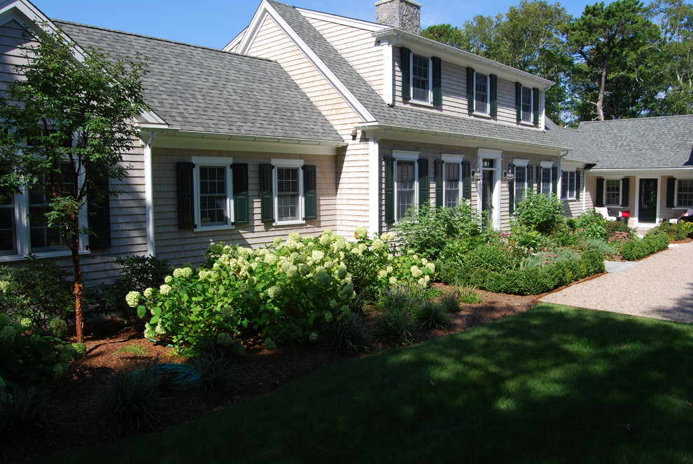 Inspiration for a large traditional full sun backyard gravel landscaping in Boston.