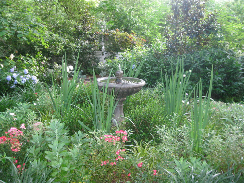 Cette image montre un aménagement d'entrée ou allée de jardin avant victorien au printemps avec une exposition ensoleillée.