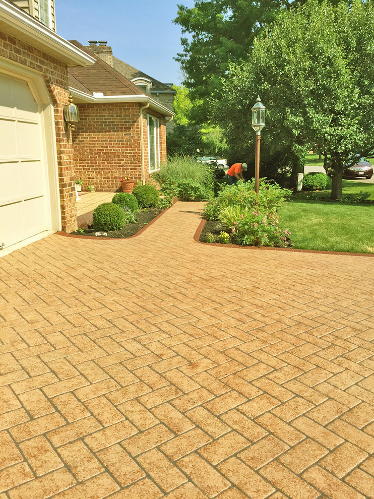 Photo of a small mid-century modern full sun front yard concrete paver driveway in DC Metro.