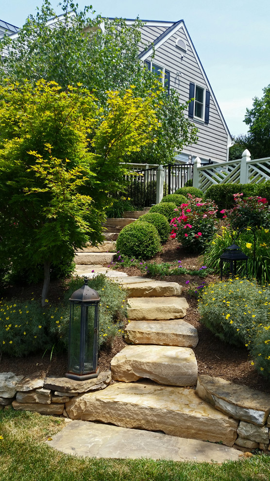 This is an example of a large rustic back full sun garden in DC Metro with a garden path and concrete paving.