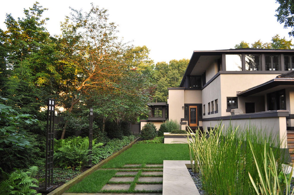This is an example of a large traditional back garden in New York with concrete paving.