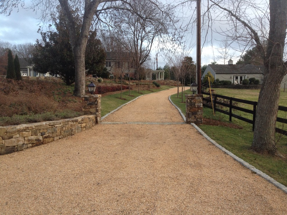 Expansive classic driveway garden in Other with gravel.
