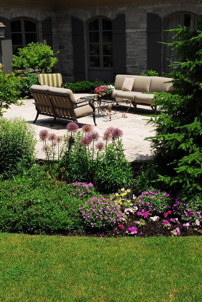 Design ideas for a large traditional partial sun backyard stone vegetable garden landscape in Toronto for spring.