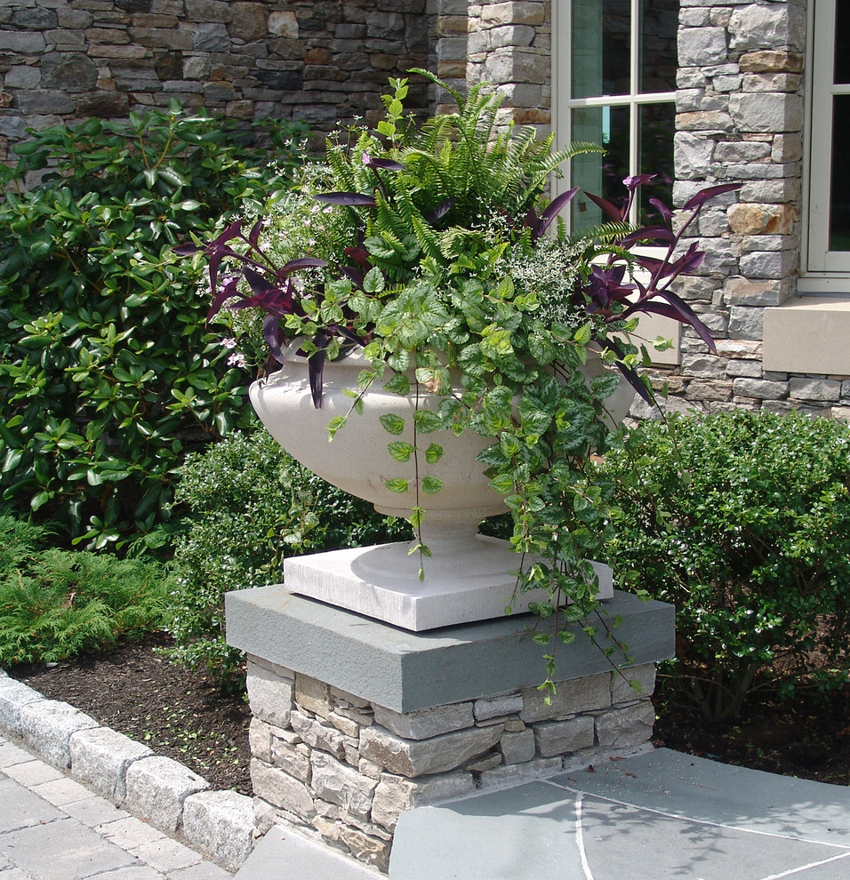 Inspiration for a large traditional shade courtyard stone landscaping in Providence for summer.
