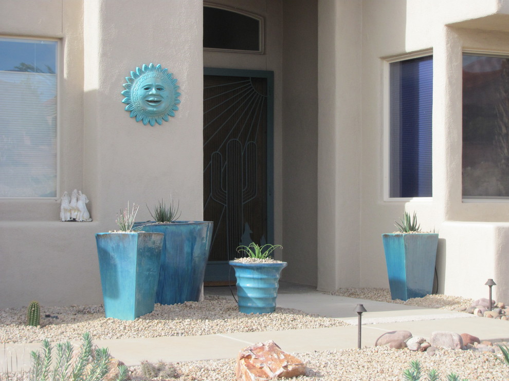 Inspiration for a medium sized front xeriscape full sun garden for spring in Other with a potted garden and gravel.