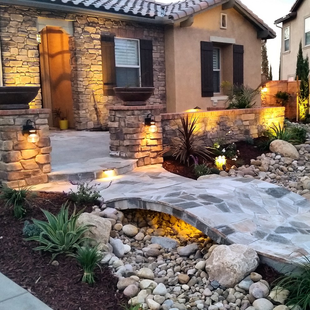 Design ideas for a medium sized mediterranean front xeriscape partial sun garden for summer in San Diego with natural stone paving.