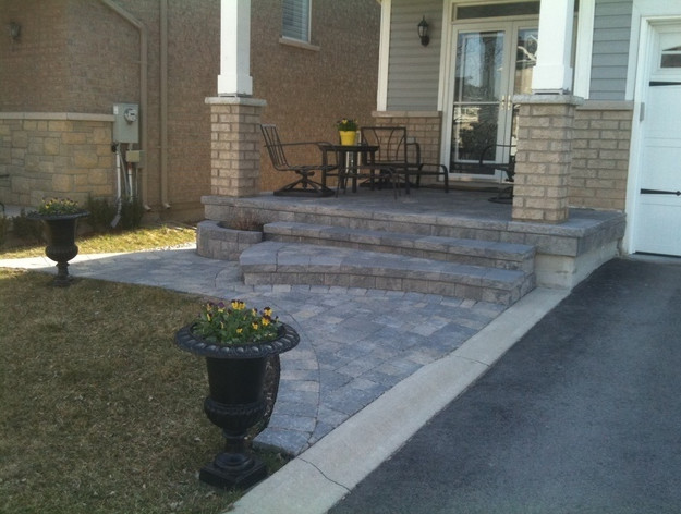 Design ideas for a mid-sized modern front yard brick driveway in Toronto.