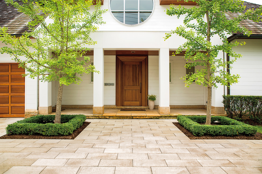 This is an example of a contemporary front yard concrete paver driveway.