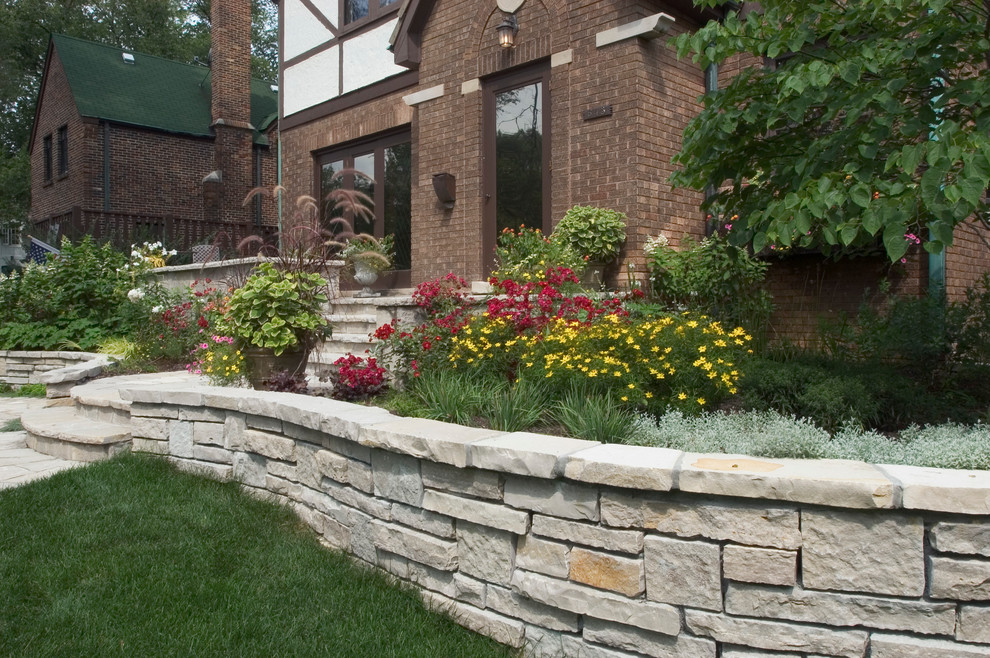 Design ideas for a small eclectic front yard stone retaining wall landscape in Chicago.