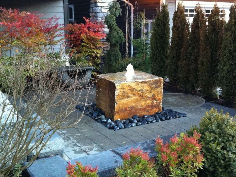 Design ideas for a small contemporary partial sun front yard brick water fountain landscape in Vancouver for spring.