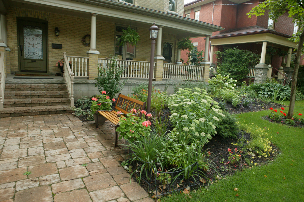 Esempio di un giardino classico in ombra di medie dimensioni e davanti casa con pavimentazioni in mattoni