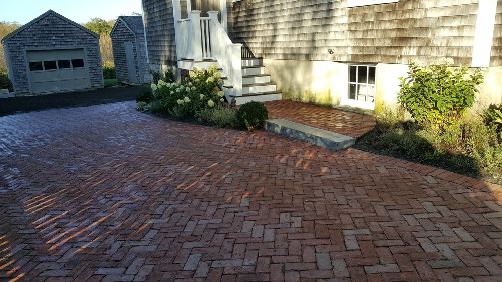 This is an example of a large traditional shade side yard brick driveway in Boston.