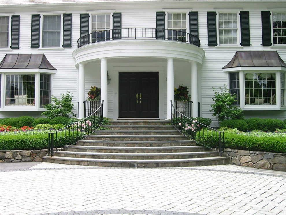 Design ideas for a large traditional partial sun front yard stone driveway in New York for fall.