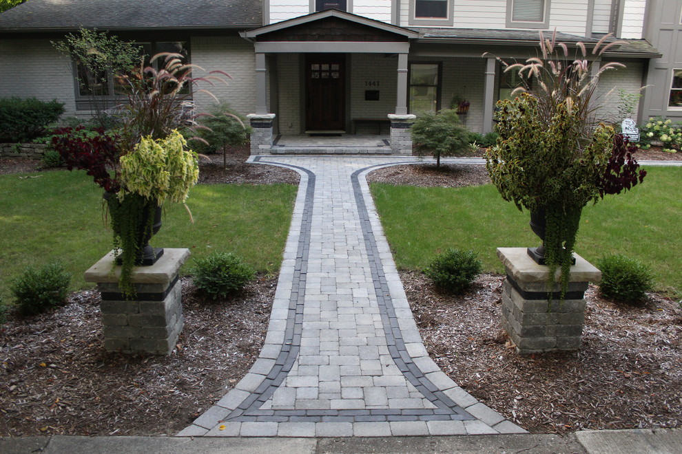 Design ideas for a large traditional front yard concrete paver landscaping in Detroit.