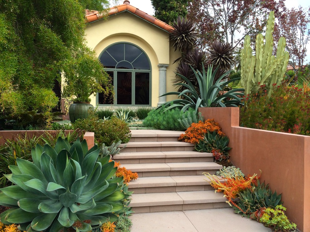 Photo of a mediterranean full sun front yard concrete paver landscaping in San Diego.