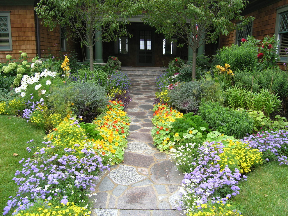 Photo of a victorian front yard stone landscaping in Minneapolis for summer.