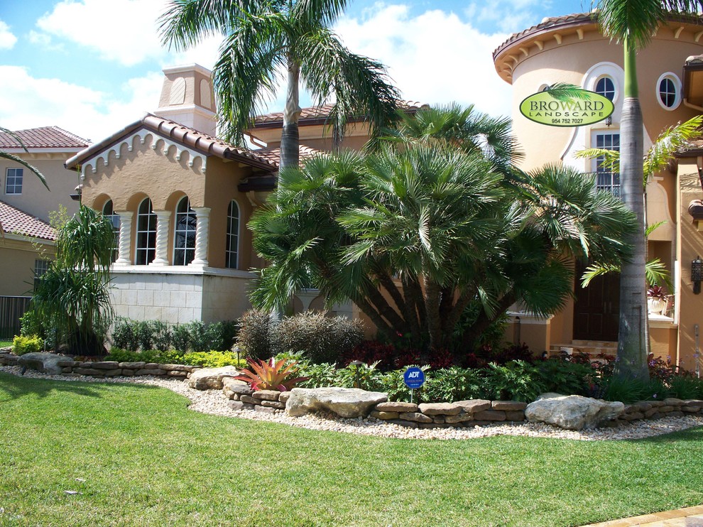 This is an example of a world-inspired front xeriscape full sun garden in Miami with gravel.