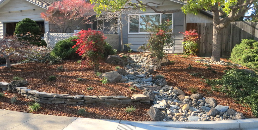 Photo of a mid-sized partial sun front yard stone landscaping in San Francisco for spring.