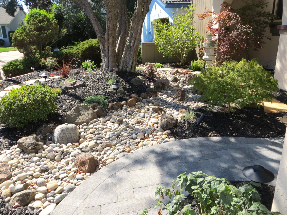 Design ideas for a mid-sized asian partial sun front yard stone landscaping in San Francisco for spring.
