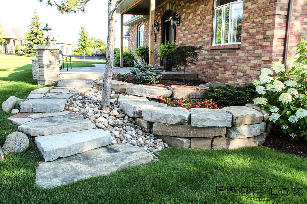 Large rustic back partial sun garden in Ottawa with a garden path and brick paving.