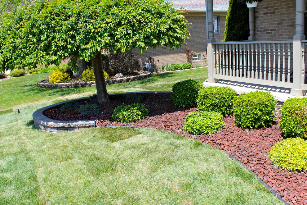 Photo of a small modern front yard concrete paver landscaping in Detroit.