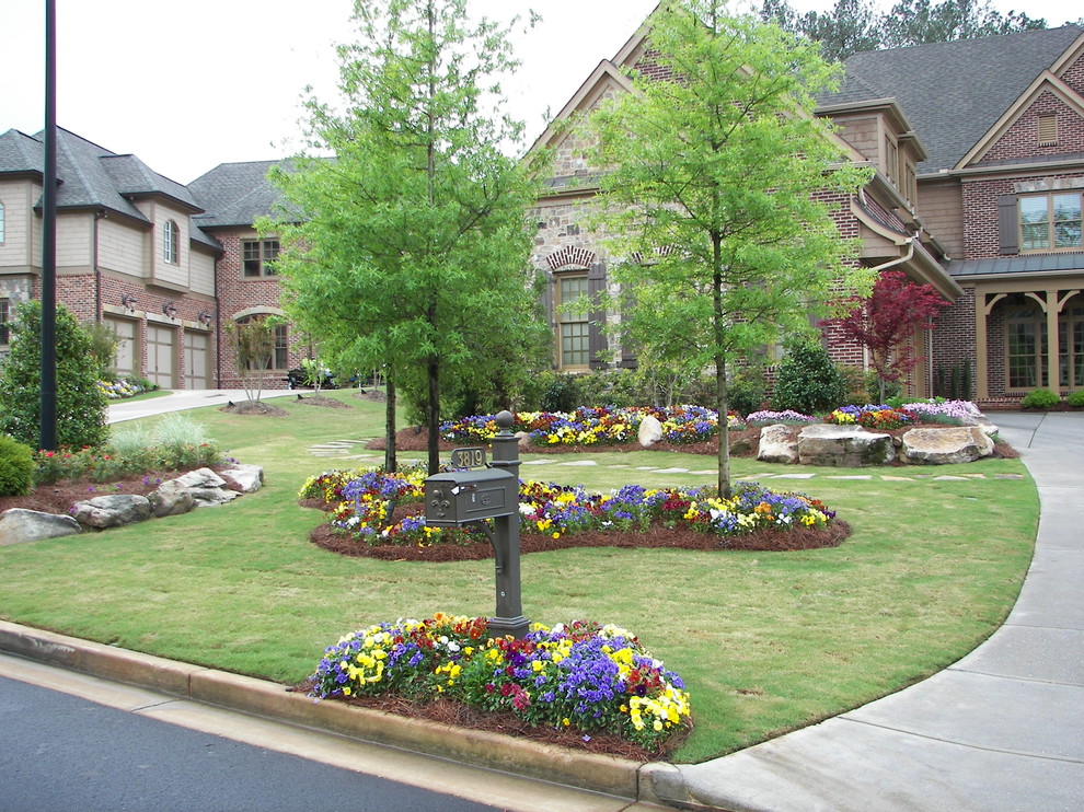 Photo of a large traditional front full sun garden in Atlanta with concrete paving.