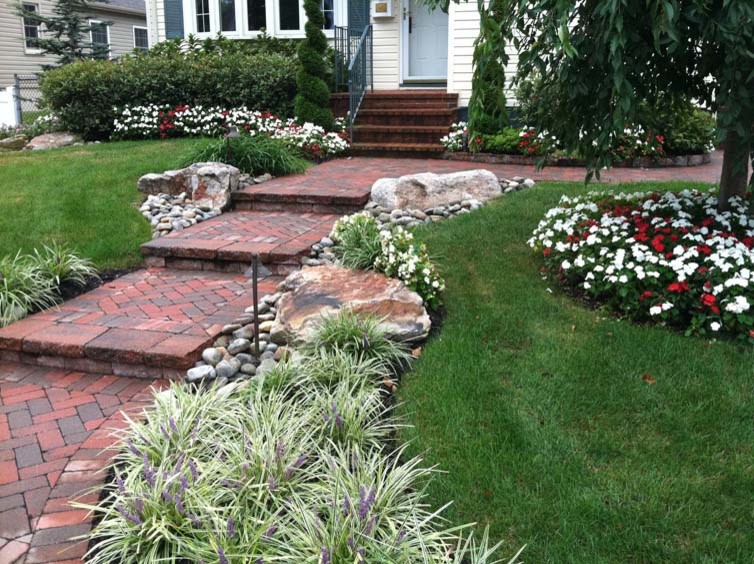 Design ideas for a mid-sized full sun front yard brick garden path in Philadelphia.