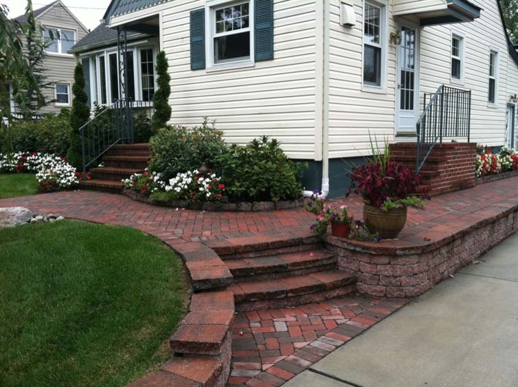 This is an example of a mid-sized full sun front yard brick garden path in Philadelphia.
