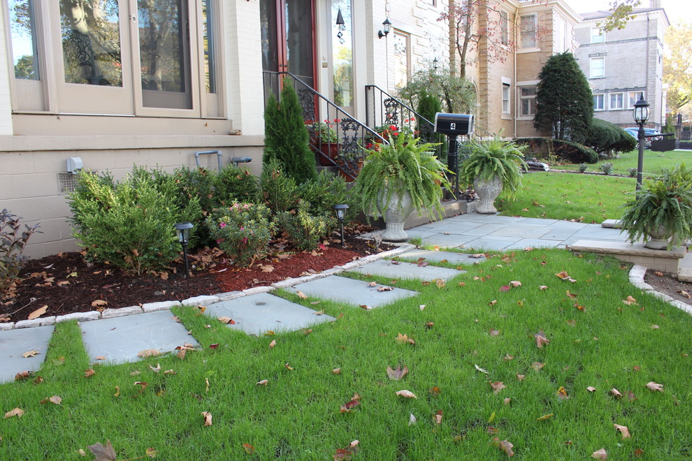 This is an example of a huge contemporary front yard stone landscaping in Other.