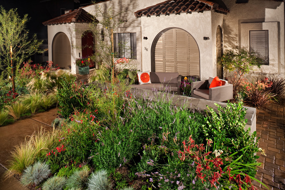 This is an example of a small modern drought-tolerant and full sun front yard concrete paver landscaping in Los Angeles with a fire pit for spring.