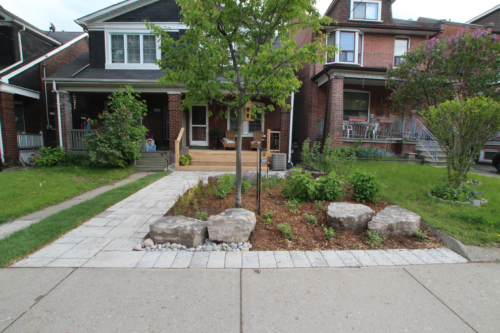 This is an example of a small contemporary full sun front yard concrete paver landscaping in Toronto.